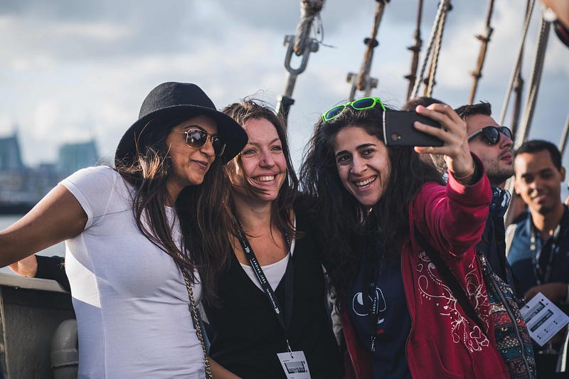 Three women taking selfies