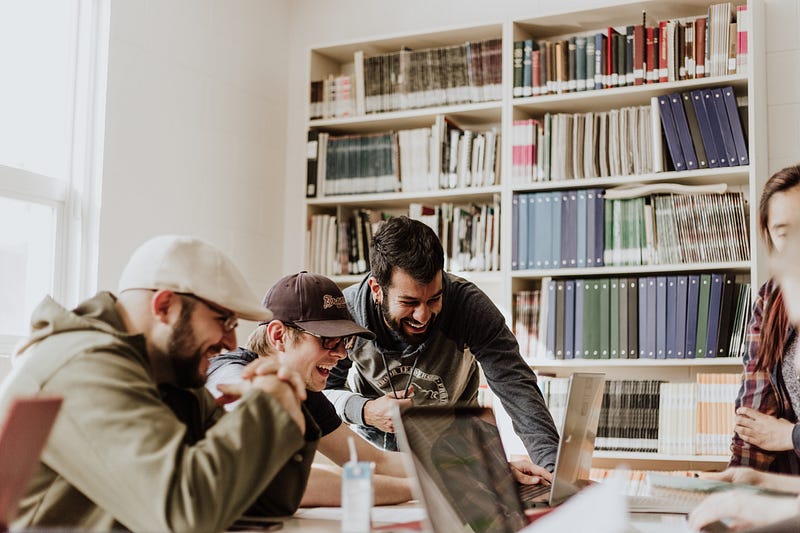Students laughing in a library