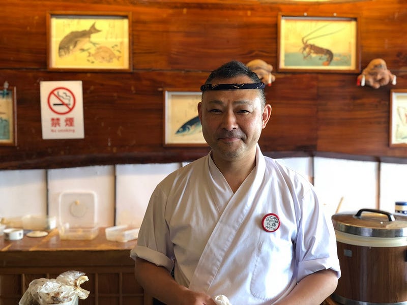 A sushi master smiles as he prepares fresh sushi for us at Asahiya Sushi Restaurant in Nezugaseki near Mt. Nihonkoku, one of the 100 Famous Mountains of Yamagata in Tohoku, north Japan