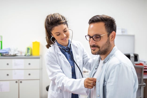 Doctor conducting a routine health check-up on a patient in a clinic.