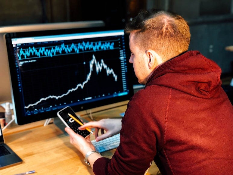 Employee visualizing data on computer monitor