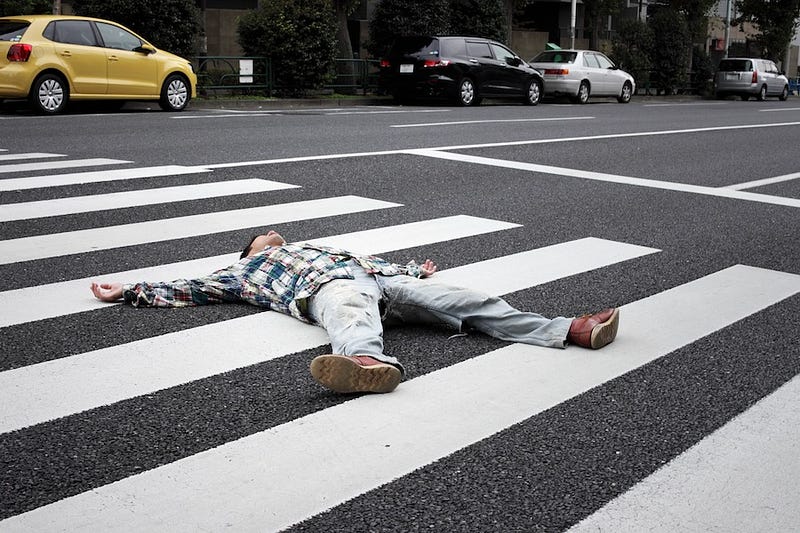 A man passes out in the middle of the street after drinking too much in Japan