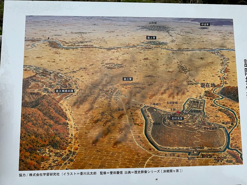 A diagram of the Keicho Dewa Kassen battle from the sky with Hasedo Castle in the foreground, Sugesawa-yama to the left, and Yamagata Castle way off in the distance.