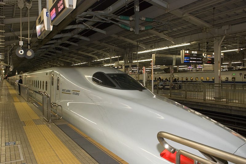 A shinkansen bullet train departs towards the Kansai region where Hikone Castle is located