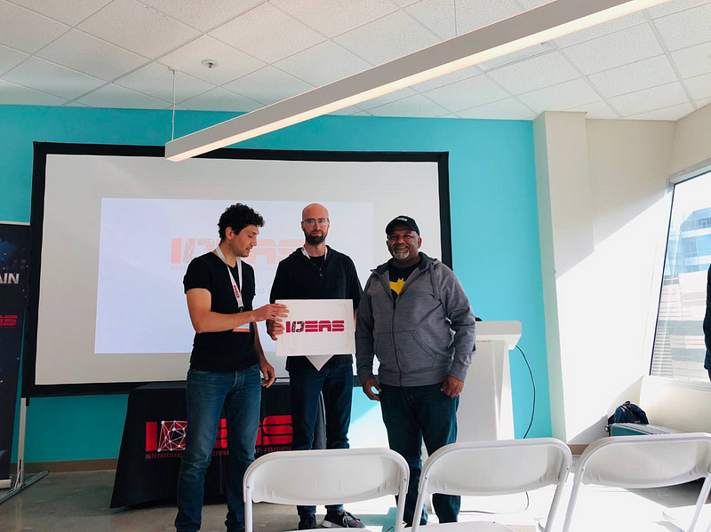 winners of hackathon holding a the IDEAS sign