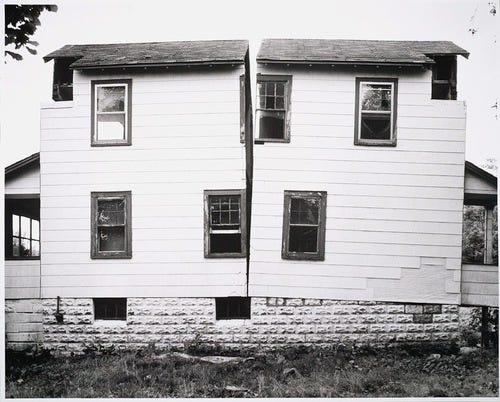 A photograph of Gordon Matta Clark's Split, a piece of conceptual art.  Courtesy of Atimidmule Multimedia, licensed under CC BY-SA 3.0.