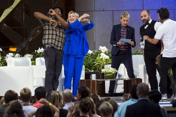 U.S. Democratic presidential candidate Hillary Clinton dances with DJ Stephen "Twitch" Boss (L) next to television host Ellen Degeneres (R) during a taping of "The Ellen Degeneres Show" in New York September 8, 2015. REUTERS/Lucas Jackson