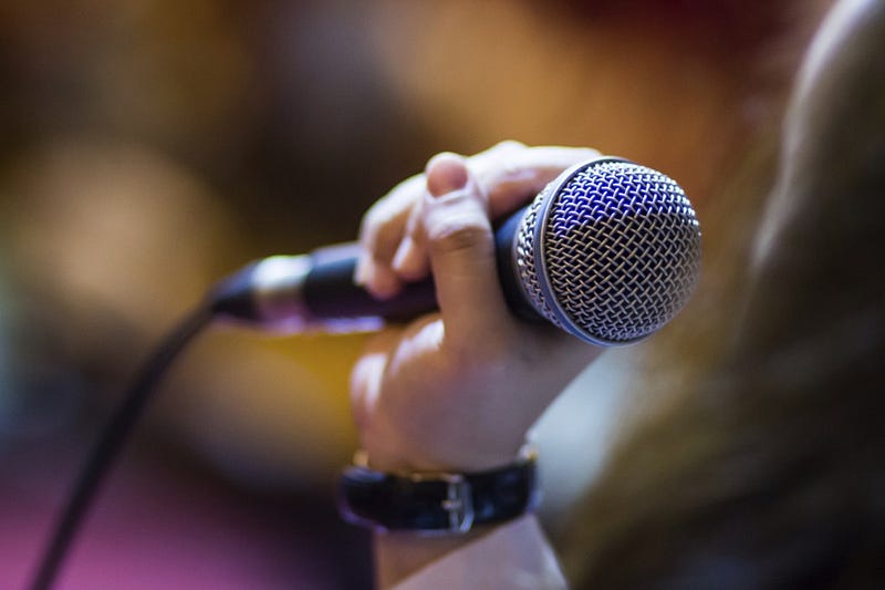 Image the announcer speaks into a microphone.