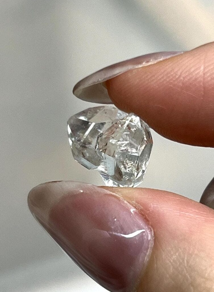 Raw gold, uncut diamonds, and natural gemstones showcasing the sourcing stage of the jewelry supply chain