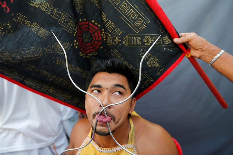 A devotee of the Chinese Samkong Shrine pierces his tongue during a procession celebrating the annual vegetarian festival in Phuket, Thailand October 4, 2016. REUTERS/Jorge Silva