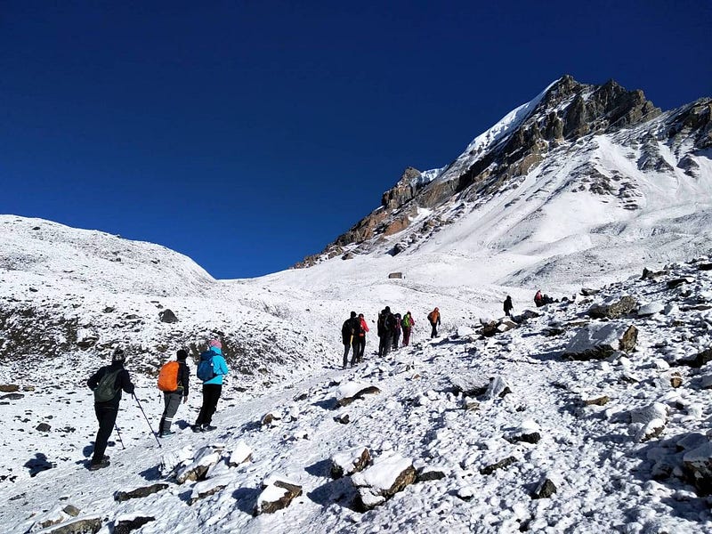 Trekkers heading towards Pass from High Camp of Annapurna Circuit trek