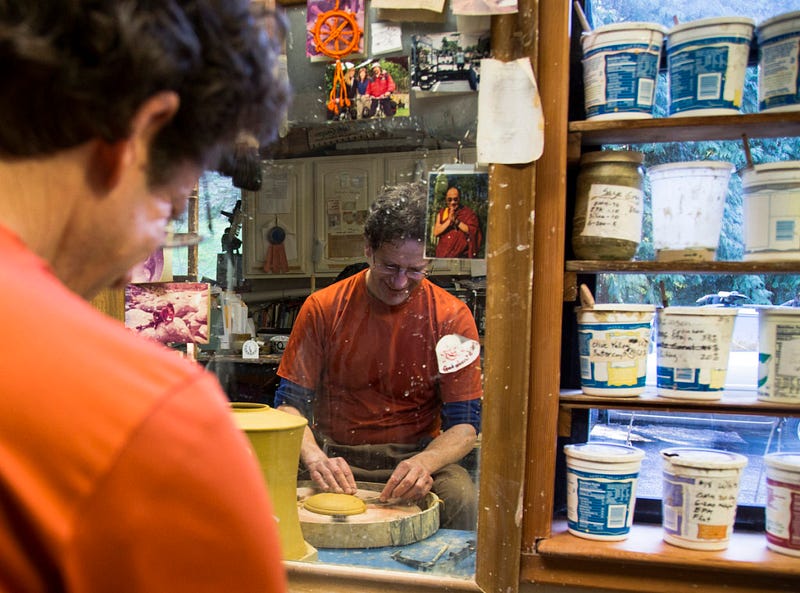 Christopher Moench makes a prayer wheel out of pottery