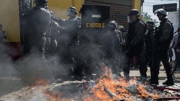 Police takes away a peaceful protester in Brasil