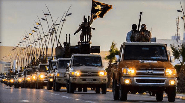 ISIS fighters parading down a street in Tripoli, Libya. (CBS News)