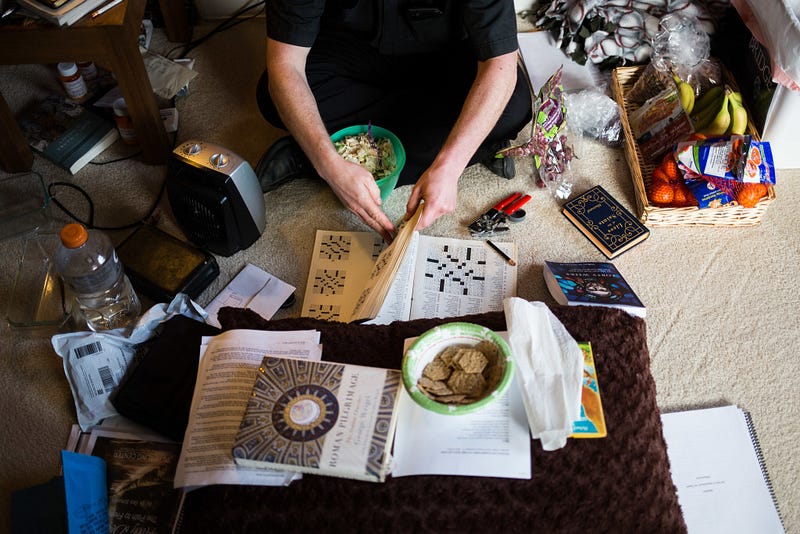 Altenhofen sits crossed-legged in a quiet red-walled room of the house, playing crosswords during his lunch break. After a busy morning, the young priest has about two hours to relax before an equally busy afternoon. 