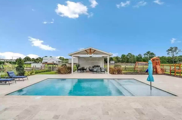 Backyard patio of Osceola County, Florida Barndominium by Leslie Mintrone 
