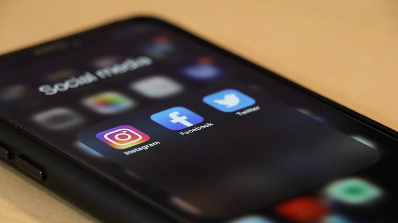 A close-up of a cell phone showing social media apps