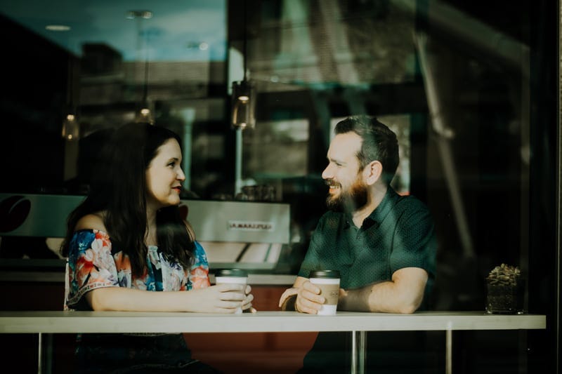 Photo of a man and a woman talking at a table