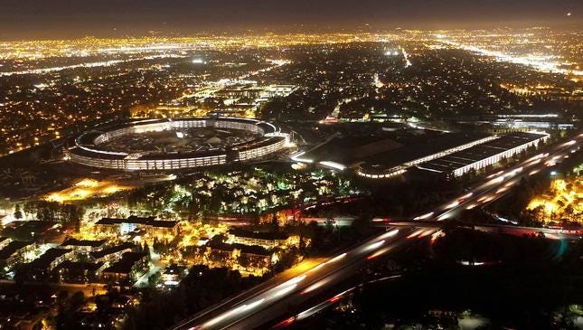 The Apple “spaceship” campus under construction; photographed at night by Duncan Sinfield using his drone, on July 22, 2016. Photo Credit: Duncan Sinfield | Source: The Meeting News
