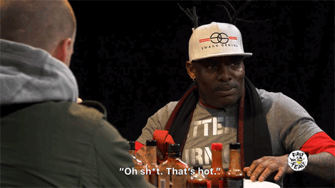 Coolio being surprised by how hot the chicken wing is after drowning it in the hottest sauce