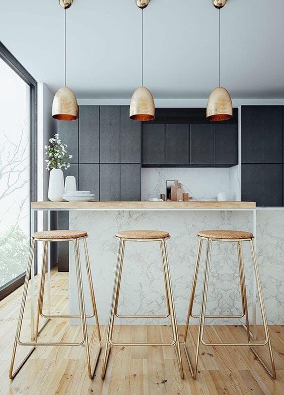 Scandinavian kitchen with rose gold lights and stools