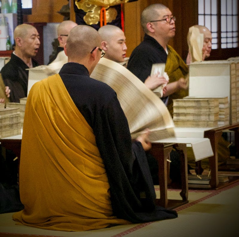 A monk at Zenpoji Temple in Tsuruoka holds a huge sutra and lets it fan down, thus absorbing the lessons contained within.