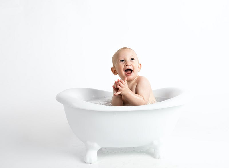 baby in a white bathtub 