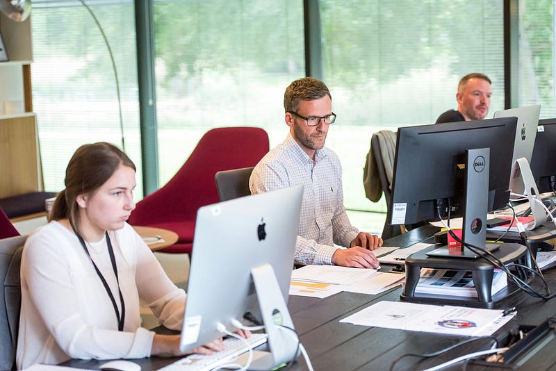 IT professionals working on desktops at office