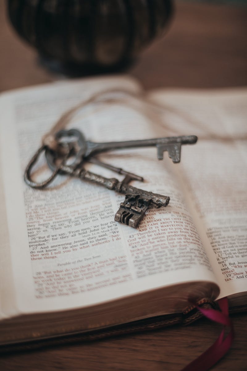 An open book with a pair of keys placed in the middle