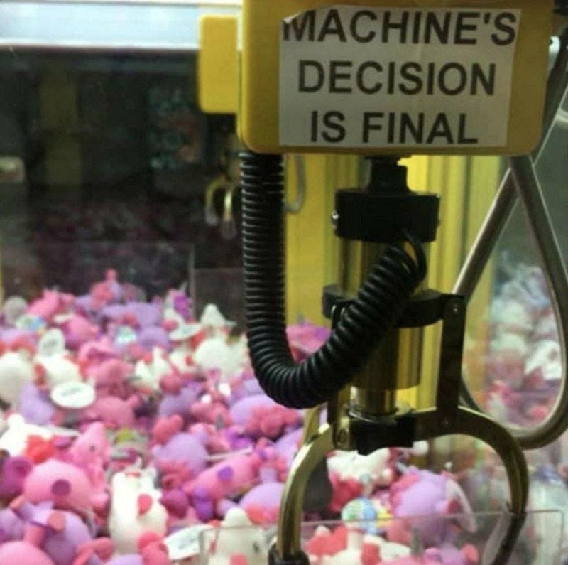 A claw hook game machine with the caption, the machine’s decision is final