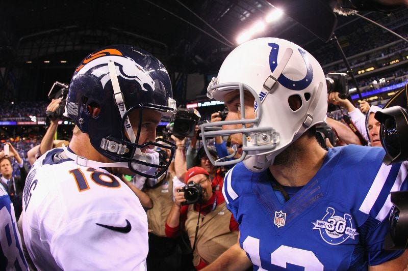 Peyton Manning (left) greets Andrew Luck at midfield following a game in 2013.