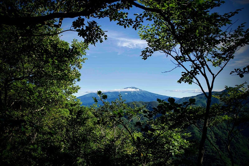 Mt. Chokai stands out surrounded 360° by foliage. Image taken from the Shumidan rock on Mt. Kyogakura, one of the 100 Famous Mountains of Yamagata located in Sakata City, in the Tohoku region of North Japan.