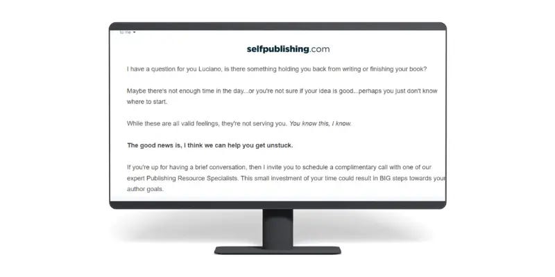 A monitor displays an email from selfpublishing.com encouraging Luciano to schedule a call for assistance with writing or finishing a book.