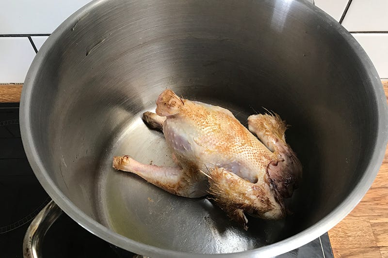 Browning the spent hen - or any meat - before simmering in liquid will take the flavour up a notch.