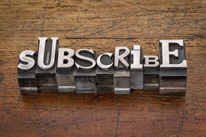 subscribe word in mixed vintage metal type printing blocks over grunge wood