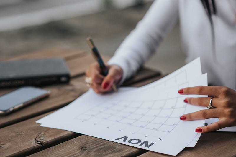 employee scheduling tasks on paper calendar