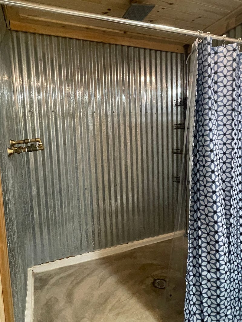 rain-head shower room in Kirk and Shannon's Bedias Barndominium

