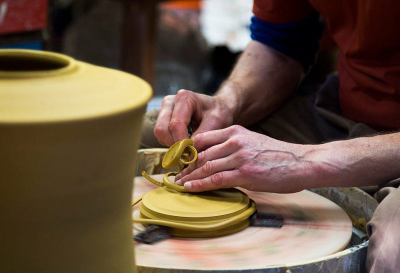 Christopher Moench trims clay off a lid in his Bellingham, WA studio