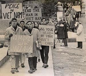 Students holding signs with messages protesting the Vietnam War.