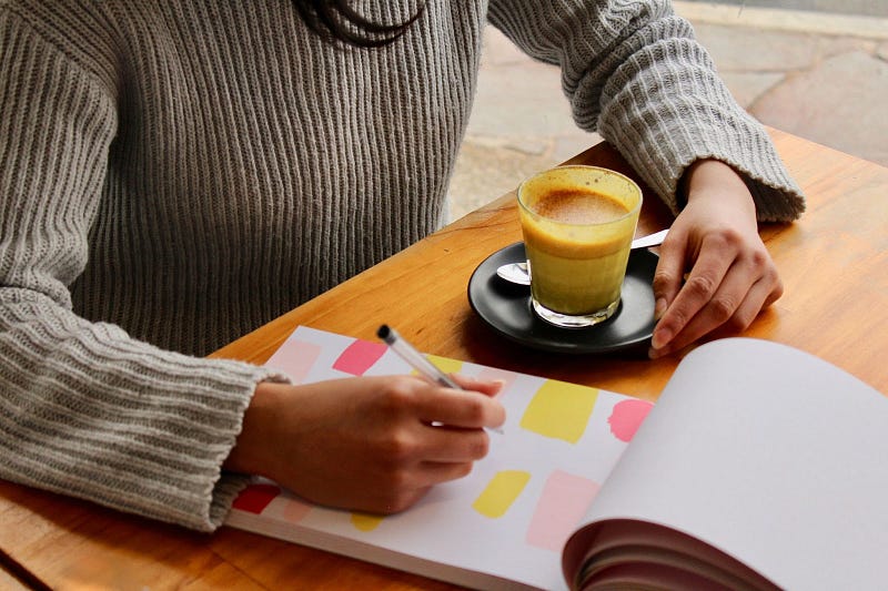 A person writing on a notepad