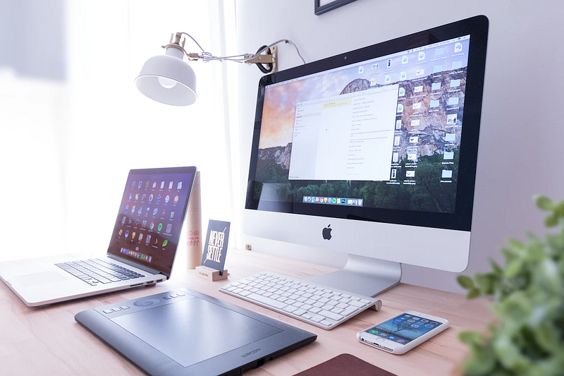 apple products on a wooden desk