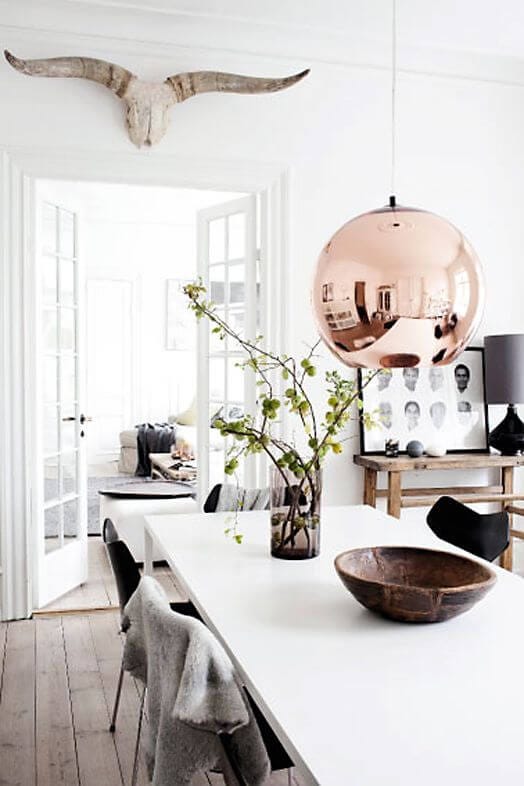 Scandinavian dining room with rose gold statement light