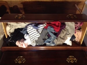 Drawer with messy pile of t-shirts
