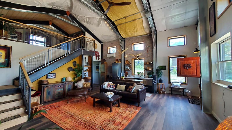 living area and kitchen with lighting fixtures and rustic decor - Colorado Barndominium