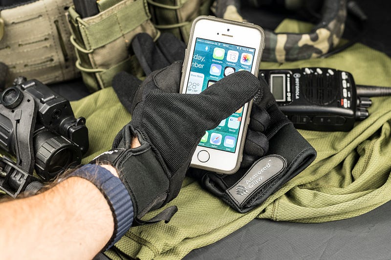 Armored Claw Shield gloves with a smartphone