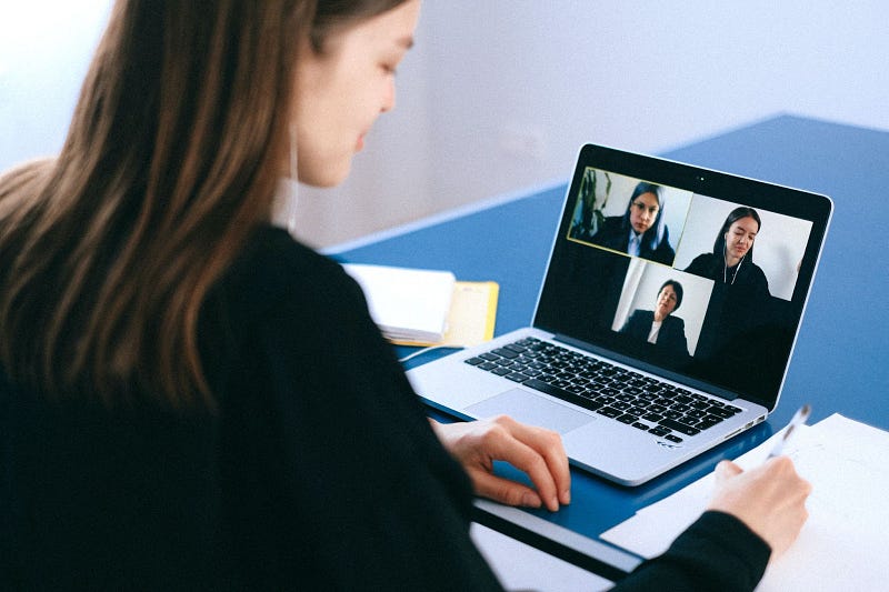 three people on a video call planning virtual team building activities