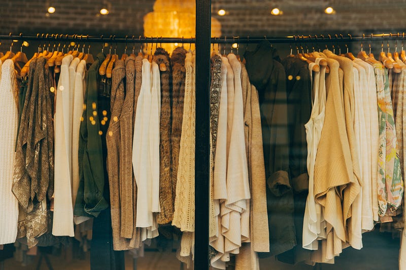 clothing, store window, fast fashion, clothing racks, shopping, neutrals. Photo by Hannah Morgan on Unsplash