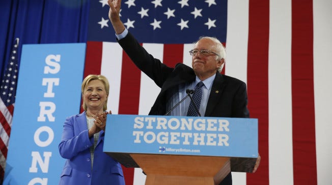 Sen. Bernie Sanders, I-Vt. waves as he a Democratic presidential candidate Hillary Clinton arrive for a rally in Portsmouth, N.H., Tuesday, July 12, 2016. (AP Photo/Andrew Harnik)