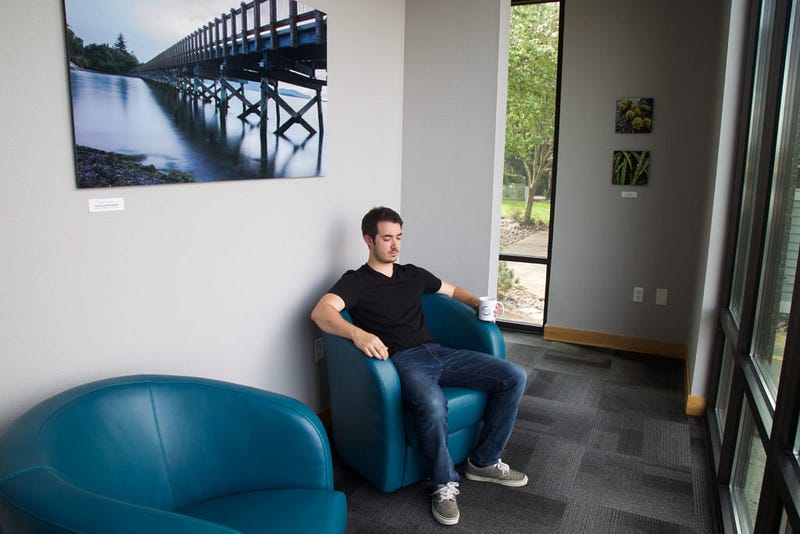 Pangborn sits and sips tea in the morning sunshine after his float session, overlooking the sailboats as they pass by in Squalicum Harbor. This room is a quiet, ambient space used to reflect on the experiences gained in the flotation tank. 