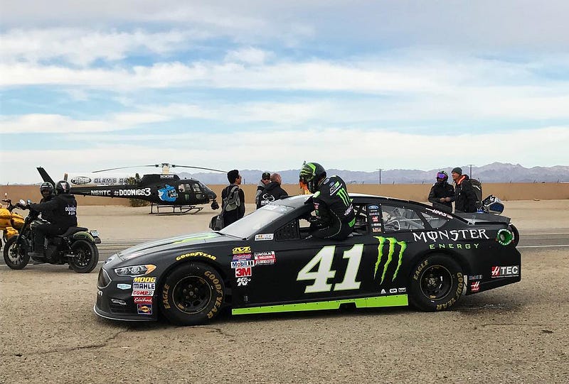Busch climbs out of his #41 Monster Energy Ford Fusion at a photoshoot. Photo from racingnews.co